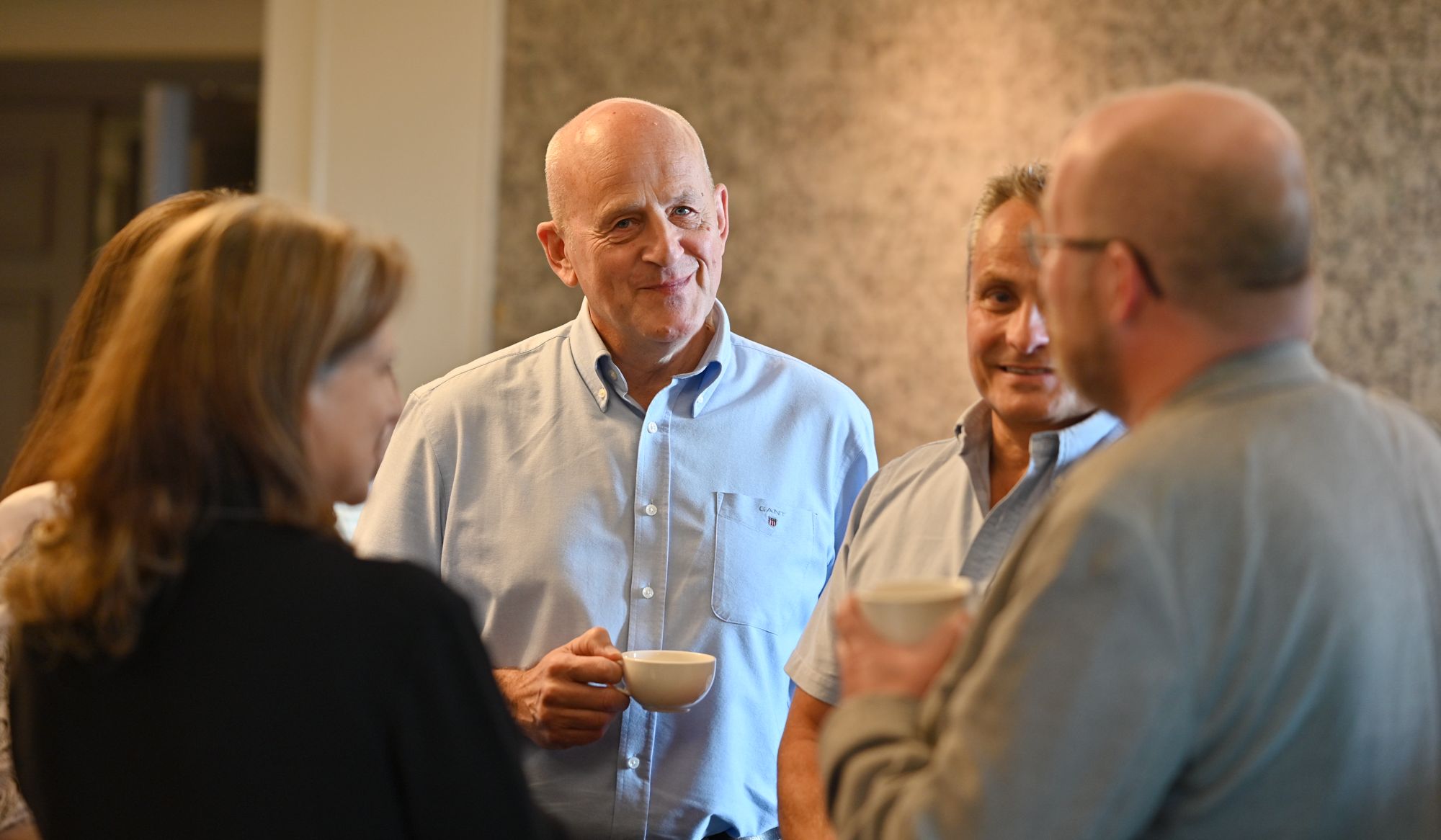 Attendees enjoying coffee while networking